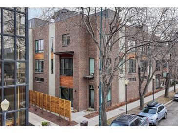 Modern brick townhome with a private fenced yard at 2432 N Washington St, Denver, CO 80205