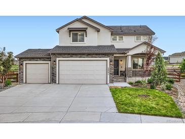 Attractive two-story home featuring a three-car garage and stone accents, showcasing its curb appeal at 16881 Roaming Elk Dr, Monument, CO 80132