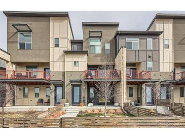 Modern townhome exterior showcasing a stylish facade, private balconies, and well-maintained landscaping at 5676 Emporia St, Denver, CO 80238
