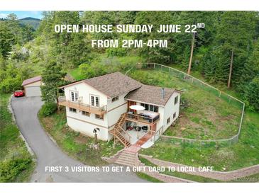 Charming multi-level home with wooden balconies and fencing, nestled in a lush, wooded area at 9648 Yegge Rd, Morrison, CO 80465