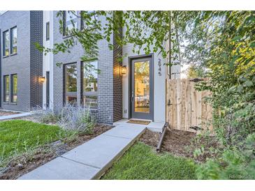 Modern two-story home with gray brick exterior and landscaped front yard at 2945 S Elati St, Englewood, CO 80110