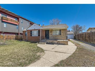 Charming brick home featuring a stone accent front porch and private driveway at 1540 Zenobia St, Denver, CO 80204