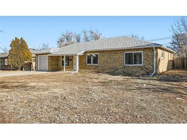 Brick ranch home with attached garage and mature trees at 1230 Peoria St, Aurora, CO 80011