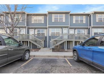 Charming townhome complex showcasing blue siding, private entrances, and well-maintained landscaping at 1888 Oakcrest Cir, Castle Rock, CO 80104