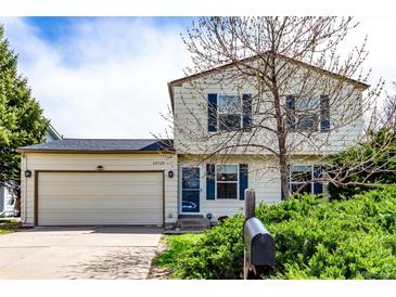 Charming two-story home featuring a two-car garage and a well-maintained front yard with mature landscaping at 10720 Moore Cir, Westminster, CO 80021