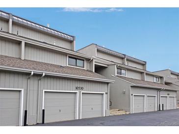 View of the exterior of the townhomes with attached garages and visible unit numbers at 10530 W Jewell Ave # 303, Lakewood, CO 80232