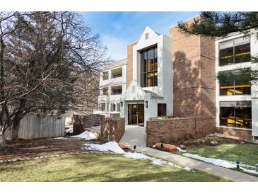 Inviting condo exterior with a well-maintained lawn, brick accents, and visible unit number at 315 Arapahoe Ave # 202, Boulder, CO 80302