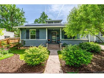 Charming single-story home featuring a landscaped front yard, covered porch, and attractive curb appeal at 3116 S Lincoln St, Englewood, CO 80113