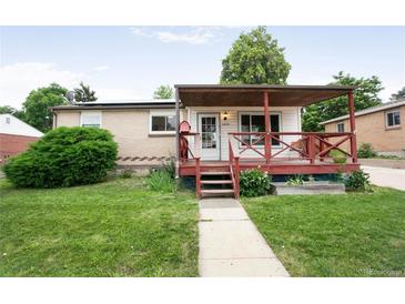 Charming home with covered porch, well-kept lawn, and walkway leading to the front door at 7839 Florado St, Denver, CO 80221
