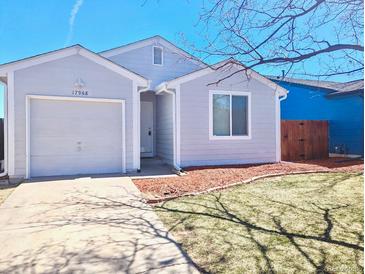 Charming single-story home featuring a front yard, attached garage, and neutral exterior at 17968 E Colgate Pl, Aurora, CO 80013