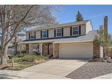 Charming two-story home features a covered front porch and attached two-car garage at 1376 S Laredo Ct, Aurora, CO 80017