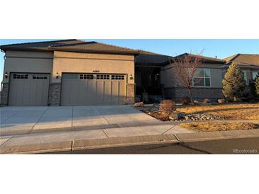 Charming single Gathering home featuring a three-car garage and beautifully landscaped front yard at 4265 Crystal Dr, Broomfield, CO 80023