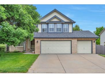 Charming two-story home featuring a three-car garage, manicured lawn and covered porch, perfect for curb appeal at 18852 E Progress Ave, Centennial, CO 80015