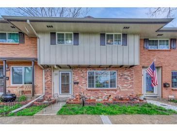 Charming brick townhouse featuring a well-manicured front yard and inviting entrance at 544 S Xenon Ct, Lakewood, CO 80228