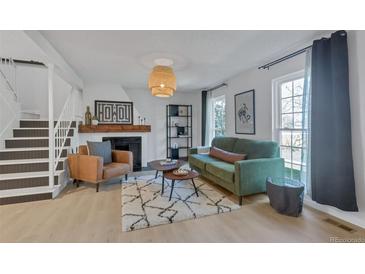 Inviting living room featuring a modern fireplace and stylish decor, creating a cozy atmosphere at 9424 E Girard Ave, Denver, CO 80231