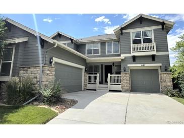 Charming two-story home featuring a two-car garage, inviting porch, and well-manicured landscaping at 687 Briar Haven Dr, Castle Pines, CO 80108