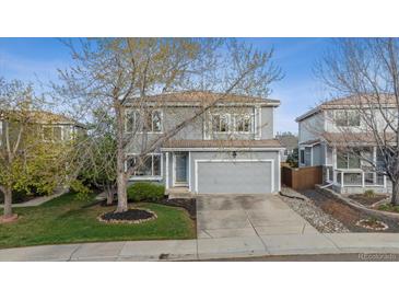 Charming two-story home with a well-manicured front yard and attached two-car garage at 4526 Lyndenwood Pt, Highlands Ranch, CO 80130