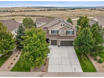 Beautiful two-story home featuring a three-car garage, surrounded by mature trees in a scenic location at 4848 Wagontrail Ct, Parker, CO 80134