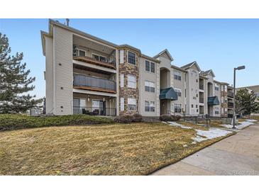 Charming condo complex featuring multi-level balconies, stone accents, and manicured landscaping at 12288 W Dorado Pl # 301, Littleton, CO 80127