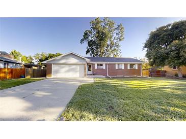 Charming single-story brick home with a well-manicured front yard and a two-car garage at 820 Cottonwood Ave, Centennial, CO 80121