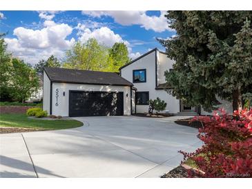 Beautifully designed home featuring a well-manicured lawn and an attached garage with a private driveway at 5516 S Havana Ct, Englewood, CO 80111