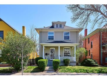 Charming two-story home with inviting front porch and well-manicured lawn, perfect for Gathering living at 424 S Pennsylvania St, Denver, CO 80209