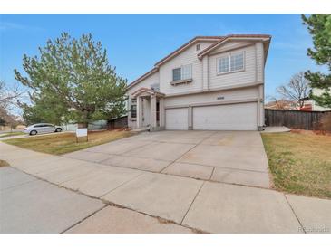 Two-story home featuring a two-car garage and well-maintained front lawn at 20308 E 46Th Ave, Denver, CO 80249