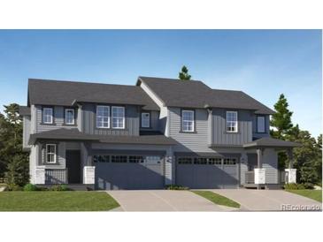 Charming two-story home featuring a modern design, complemented by a two-car garage and inviting entryway at 557 Nightsky St, Erie, CO 80516