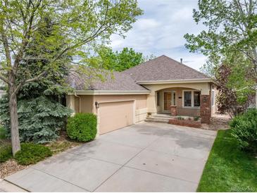Charming single-story home with a well-manicured lawn, inviting curb appeal, and an attached two-car garage at 15851 Deer Ridge Dr, Morrison, CO 80465