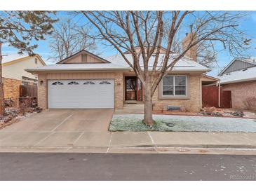 Charming single-story brick home featuring a two-car garage and manicured front yard at 710 Kittredge St, Aurora, CO 80011