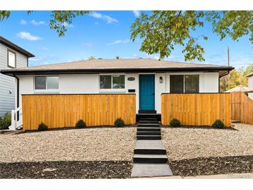Charming home featuring a bright blue door, modern landscaping, and a freshly painted exterior at 3220 W 8Th Ave, Denver, CO 80204