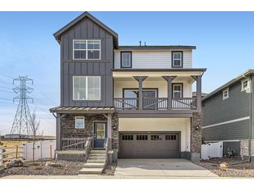 Charming two-story home with stone accents and a welcoming covered porch and a spacious garage at 2050 S Haleyville Way, Aurora, CO 80018