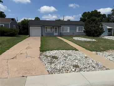 Charming home featuring a cracked driveway, rock accents, and a well-maintained, inviting exterior at 3041 S Glencoe St, Denver, CO 80222