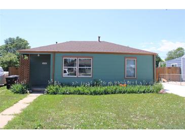 Charming single-story home features a well-maintained lawn and beautiful flower beds along the front of the house at 1730 W 51St Ave, Denver, CO 80221