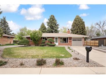 Charming single-story brick home with a well-manicured lawn and mature landscaping at 10525 W 18Th Ave, Lakewood, CO 80215