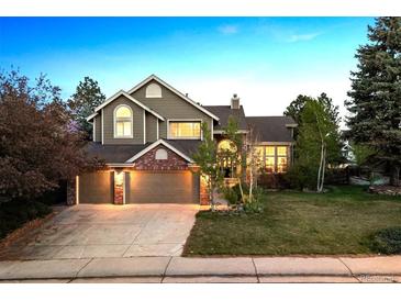 Charming two-story home with a three-car garage and beautifully landscaped front yard at 2317 Wynterbrook Dr, Highlands Ranch, CO 80126