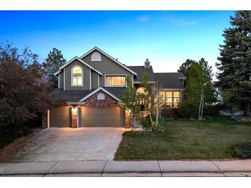 Charming two-story home features a three-car garage and a well-manicured front lawn at 2317 Wynterbrook Dr, Highlands Ranch, CO 80126