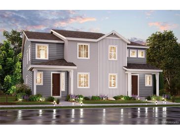 Charming two-story home with gray siding, manicured lawn, and inviting front entrance, creating a welcoming curb appeal at 14105 Deertrack Ln, Parker, CO 80134