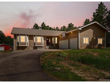Charming ranch-style home with a driveway and a two-car garage on a large lot with mature trees at 20125 Indi Dr, Monument, CO 80132