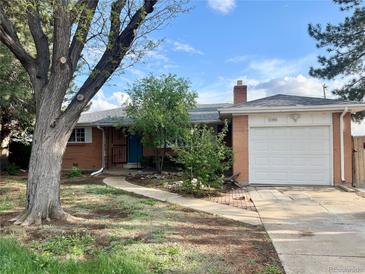 Charming single-story home with brick exterior, manicured lawn, and attached garage in a residential neighborhood at 1088 Douglas Dr, Denver, CO 80221