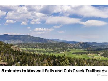 Breathtaking mountain and valley views with lush forests and expansive blue skies, an ideal setting for nature lovers at 6882 Snowshoe Trl, Evergreen, CO 80439