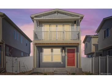 Charming two-story home with a balcony and a red front door under a beautiful sky at 5035 N Walden Way, Denver, CO 80249