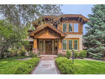 Charming home featuring a beautiful wood facade, brick accents, and a welcoming entryway with landscaped yard at 1410 S Elizabeth St, Denver, CO 80210