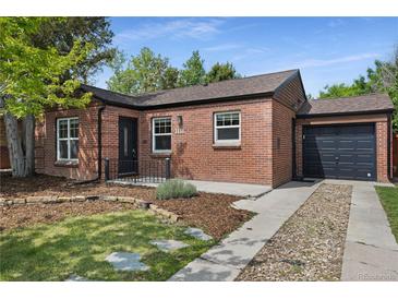 Charming brick home featuring a well-maintained front yard and a one-car attached garage at 1111 Kearney St, Denver, CO 80220