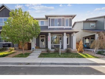 Charming two-story home features a covered front porch and well-maintained landscaping at 6834 Clay N St, Denver, CO 80221