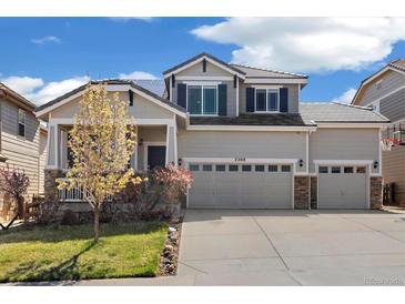 Charming two-story home featuring a three car garage, landscaped front yard, and attractive architectural details at 2208 Bellavista St, Castle Rock, CO 80109