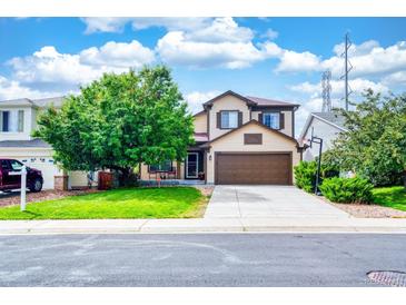 Inviting two-story home with a cozy front porch and a well-manicured lawn at 22160 Wintergreen Way, Parker, CO 80138