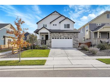Beautiful two-story home boasts stone accents and a large two car garage at 10912 Memphis Ct, Commerce City, CO 80022