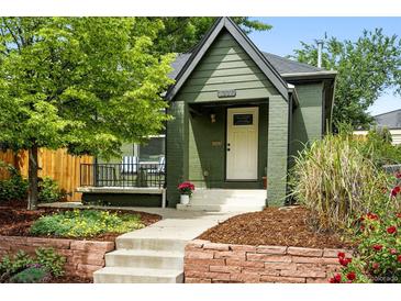 Charming home with an inviting front porch, beautiful landscaping, and a well-maintained exterior at 1331 Osceola St, Denver, CO 80204