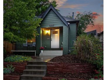 Charming home with an inviting front porch, beautiful landscaping, and a well-maintained exterior at 1331 Osceola St, Denver, CO 80204